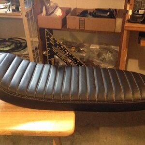 My seat, freshly upholstered. Bent the pan myself, layered yoga mat for the padding. Black leather and silver stitching