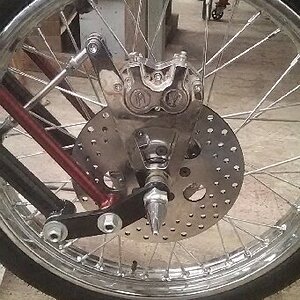 Took a heck of a long time to find a brake rotor that would work with a narrow fork and shoulder bolts.  Finally found '73 FL 10" rotor would work, wi