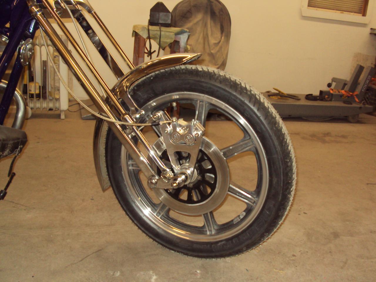 I was able to reuse the original wheel,disc,speedo drive,and fender.I used a P.M. 4 piston caliper.
