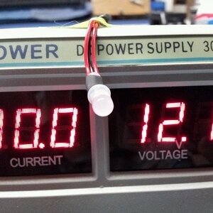 LED test, using freshly calibrated power supply.
At 12.1vdc, LED flashes red.
Sorry, can't catch this in pic, but shows how testing was done.