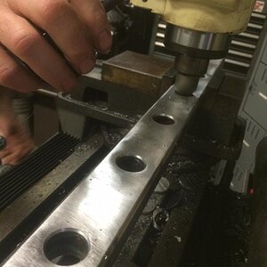 Chamfering the holes after I welded 1.25" DOM into them and smoothed them out.